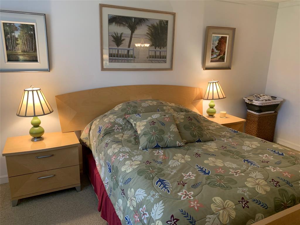 1541 South Ocean Boulevard, Unit 122 Pompano Beach, FL 33062 - Photo 7 of 30 a bedroom with a bed and painting on the wall