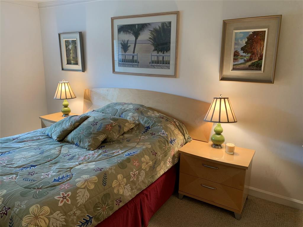 1541 South Ocean Boulevard, Unit 122 Pompano Beach, FL 33062 - Photo 8 of 30 a bedroom with a bed and a lamp on dresser