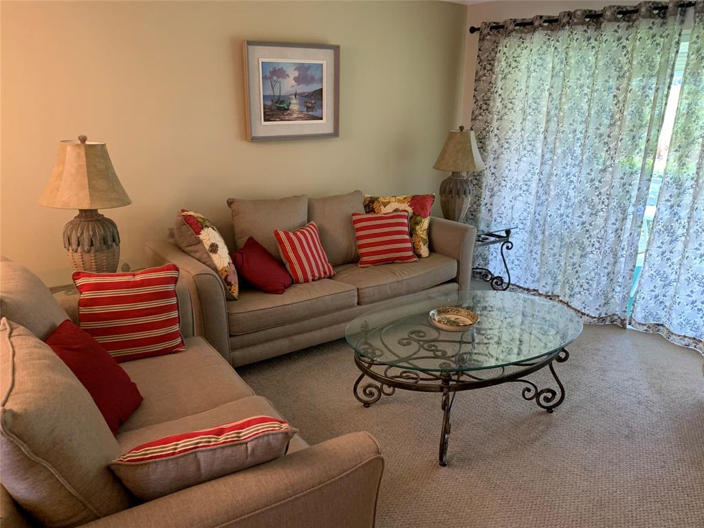 1541 South Ocean Boulevard, Unit 122 Pompano Beach, FL 33062 - Photo 10 of 30 a living room with furniture and a lamp