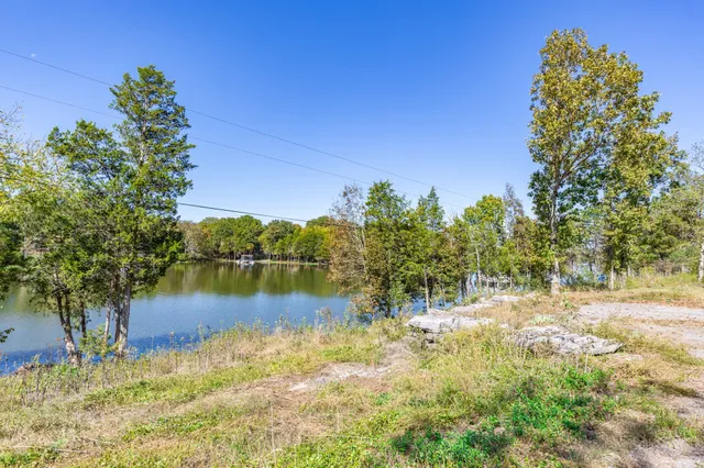 view of a lake with houses in the back