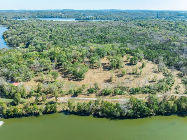 a backyard of a house with a yard and outdoor seating