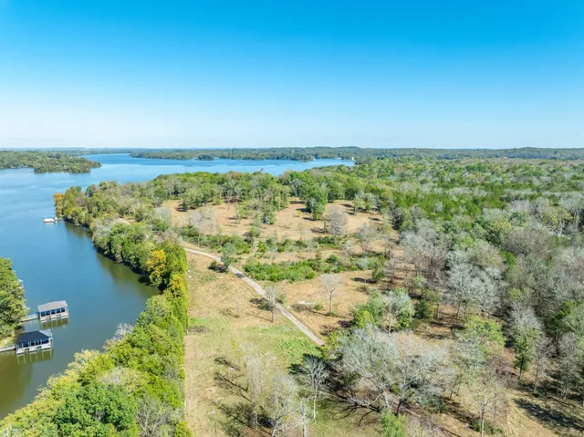 a view of a lake with houses in the back