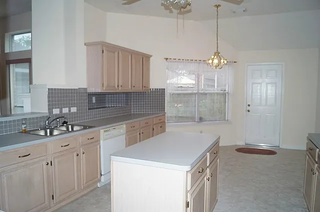 a kitchen with a sink cabinets and window