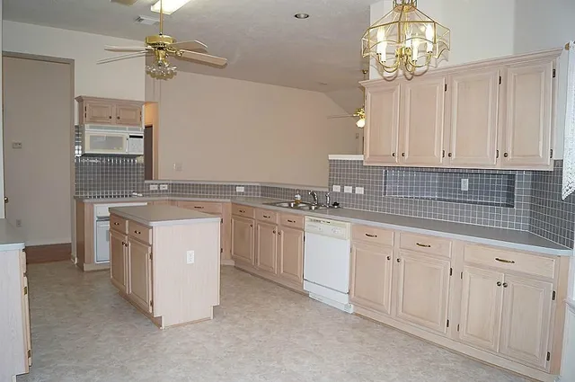 a kitchen that has a lot of cabinets in it