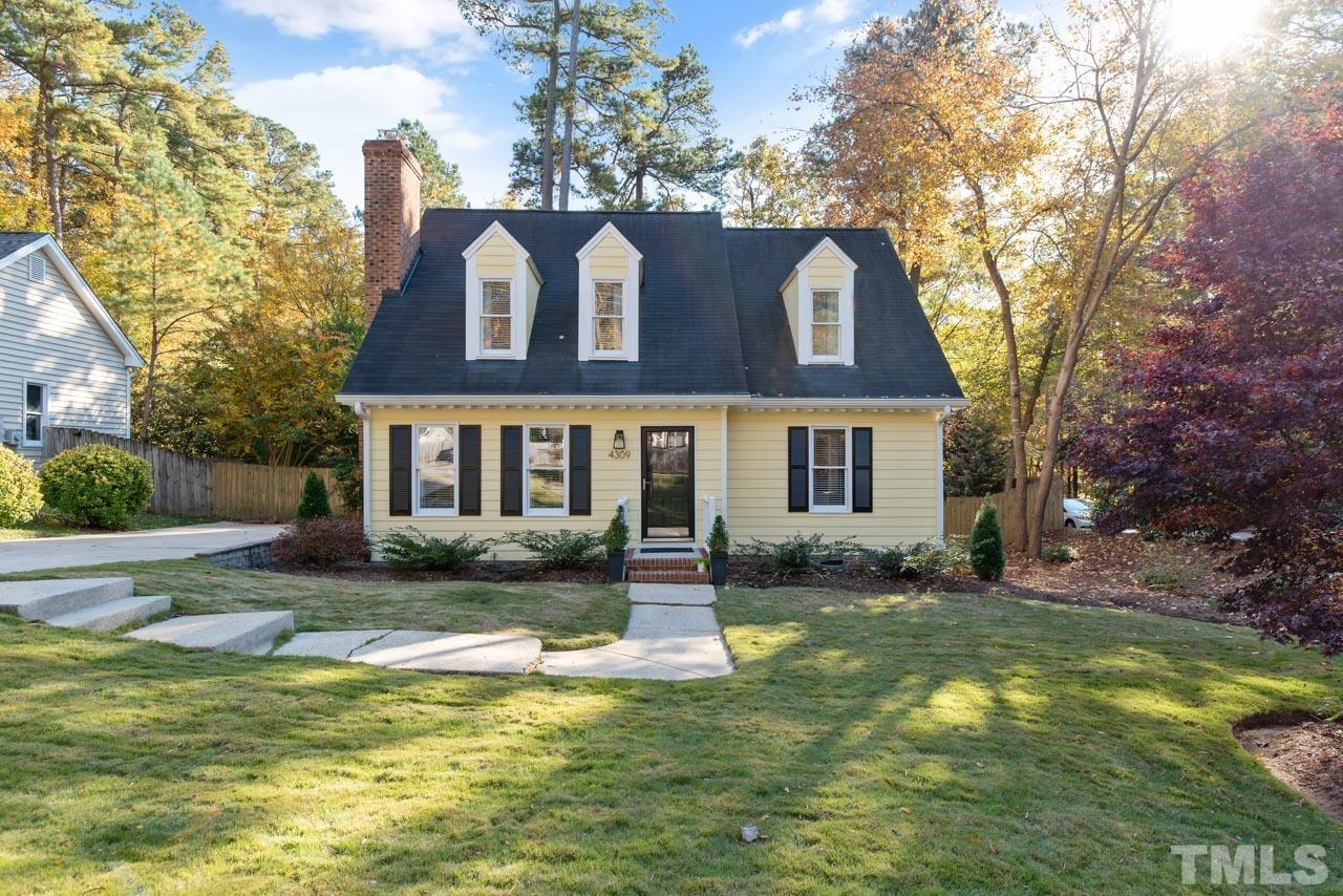 4309 Pleasant Grove Church Road Raleigh, NC 27613 - Photo 1 of 29 a front view of a house with a yard table and chairs