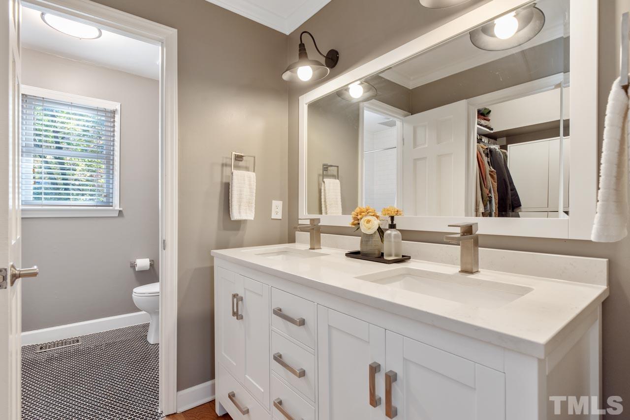 4309 Pleasant Grove Church Road Raleigh, NC 27613 - Photo 12 of 29 a bathroom with a sink and a mirror