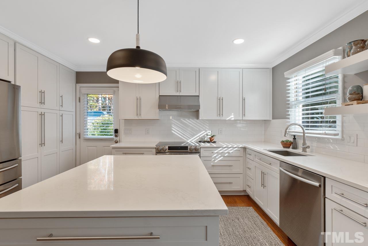 4309 Pleasant Grove Church Road Raleigh, NC 27613 - Photo 15 of 29 a kitchen with a sink a stove and window