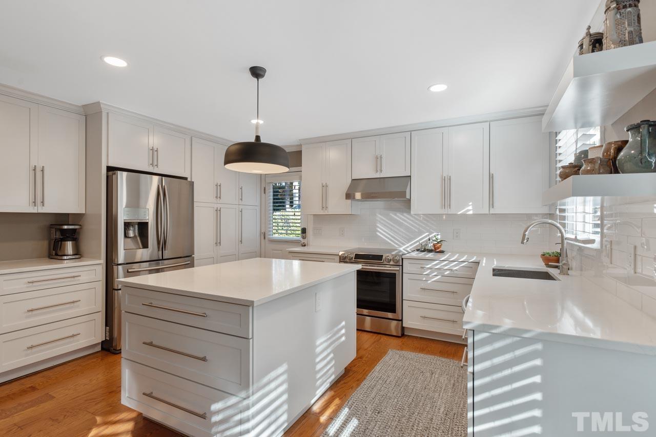 4309 Pleasant Grove Church Road Raleigh, NC 27613 - Photo 16 of 29 a kitchen with stainless steel appliances granite countertop a sink stove and refrigerator