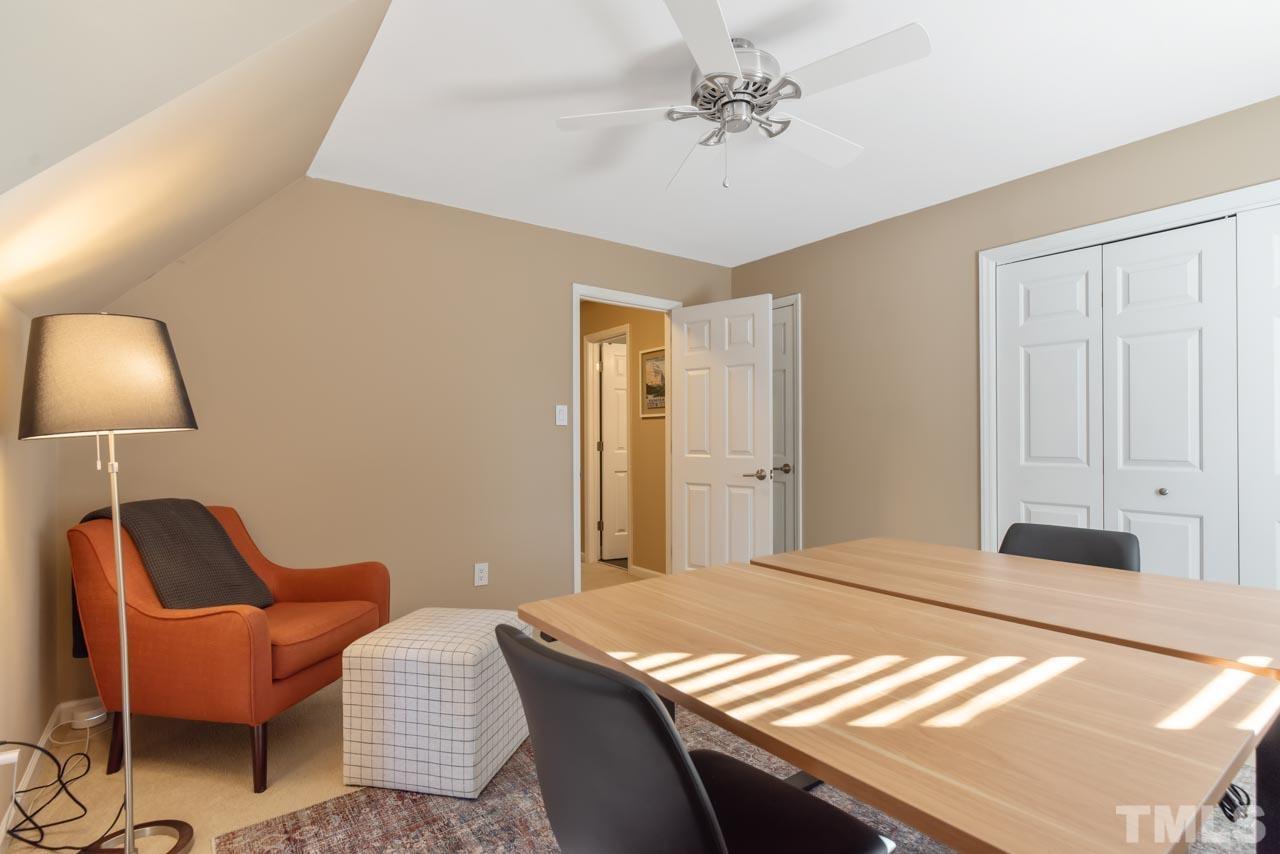 4309 Pleasant Grove Church Road Raleigh, NC 27613 - Photo 20 of 29 a bedroom with a bed and a chandelier