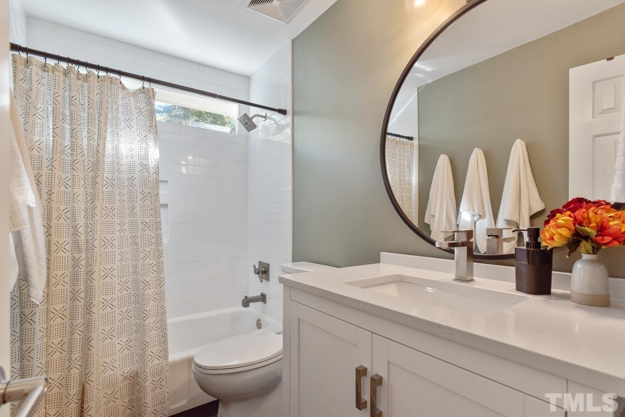 4309 Pleasant Grove Church Road Raleigh, NC 27613 - Photo 23 of 29 a bathroom with a granite countertop sink a toilet and a mirror