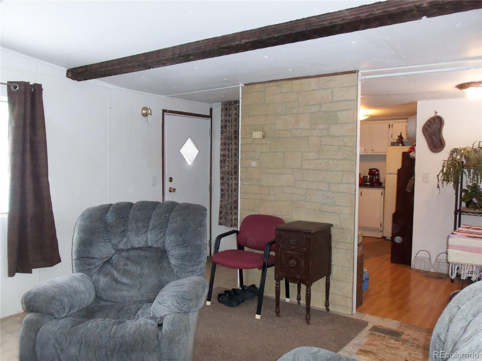 709 5th Street Hugo, CO 80821 - Photo 7 of 9 a living room with furniture and a fireplace