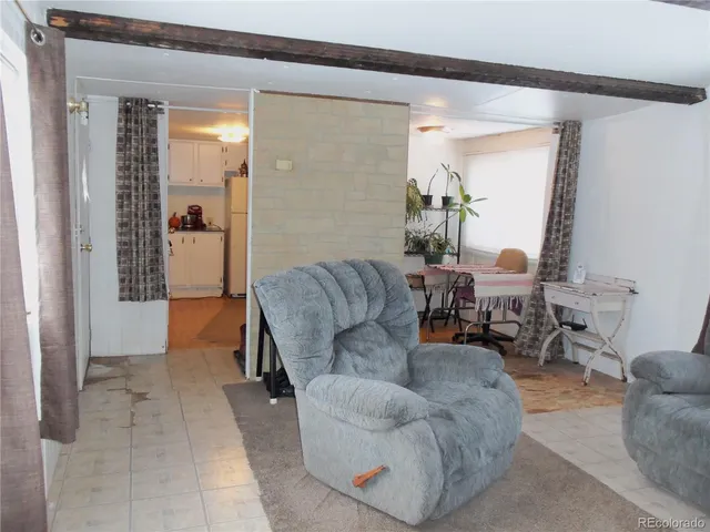 a living room with furniture and a dining table