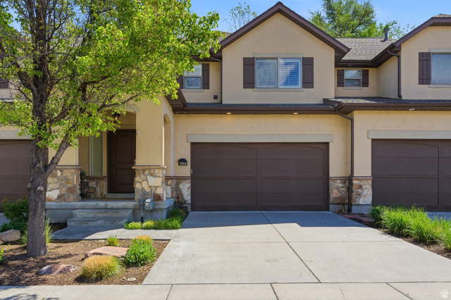7235 Viansa Court Midvale, UT 84047 - Photo 39 of 43 Traditional-style house with stone siding, stucco siding, concrete driveway, and an attached garage