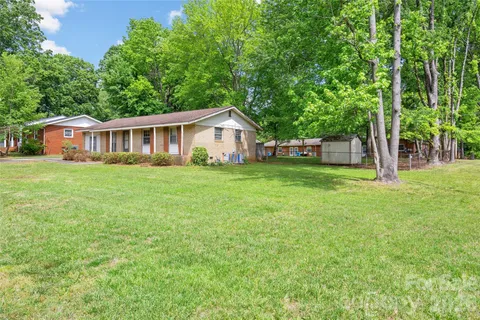 a view of a house with a yard and sitting area
