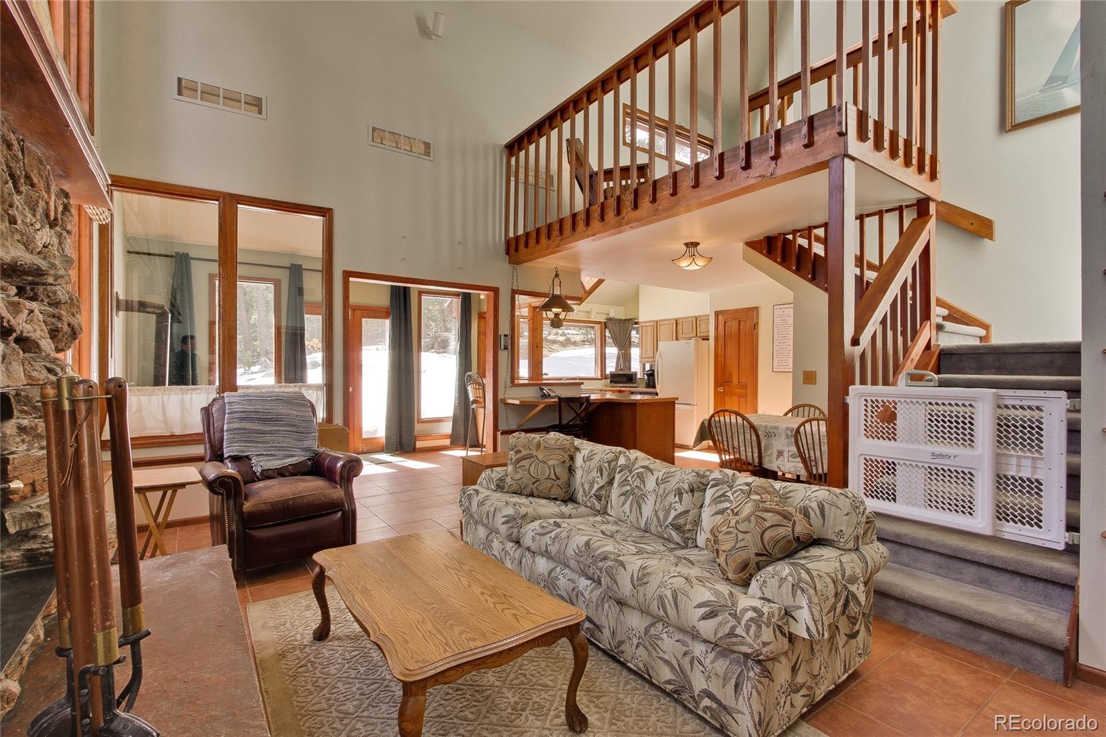222 Ridge Road Ward, CO 80481 - Photo 12 of 40 a living room with furniture and a large window