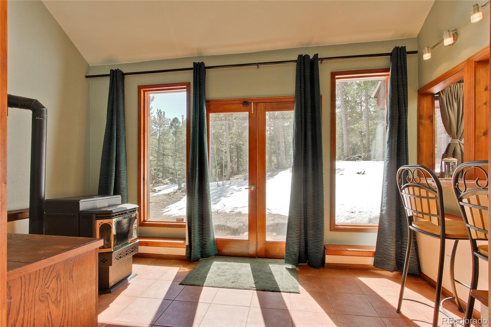 222 Ridge Road Ward, CO 80481 - Photo 17 of 40 a hallway with a large window and furniture