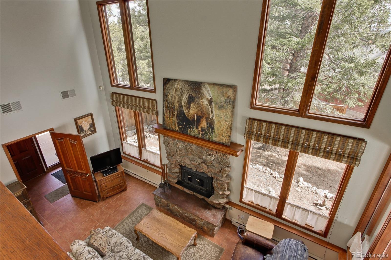 222 Ridge Road Ward, CO 80481 - Photo 6 of 40 a living room with furniture and a fireplace