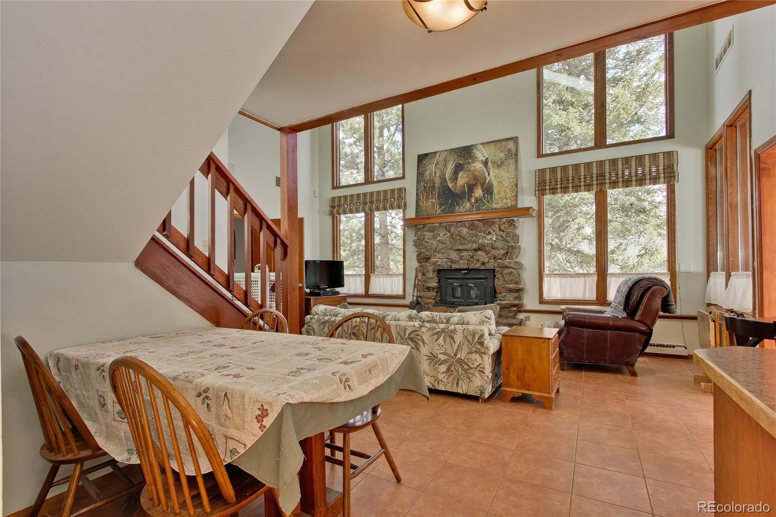 222 Ridge Road Ward, CO 80481 - Photo 8 of 40 a living room with furniture a fireplace and large windows