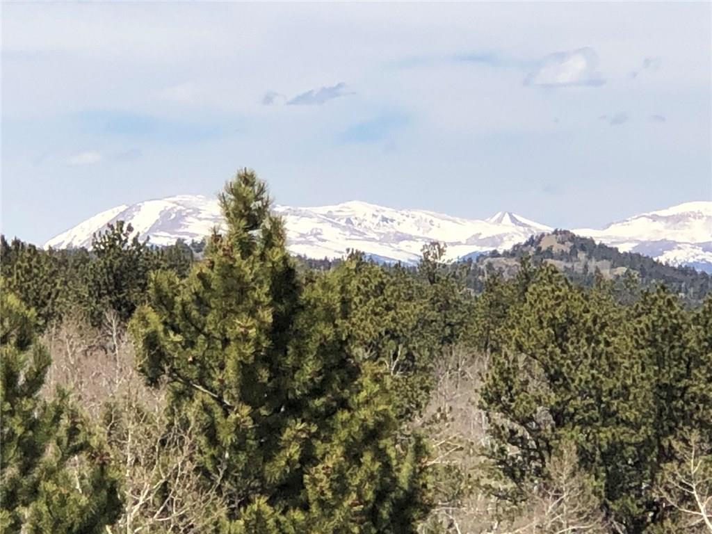 10380 Ranch Road Hartsel, CO 80449 - Photo 17 of 18 a view of a large building with mountains in the background