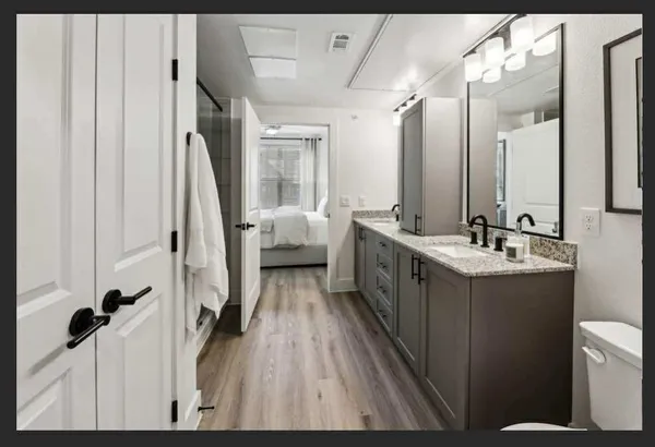 a bathroom with a double vanity sink and mirror
