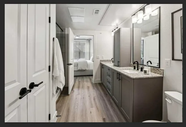 a bathroom with a double vanity sink and mirror