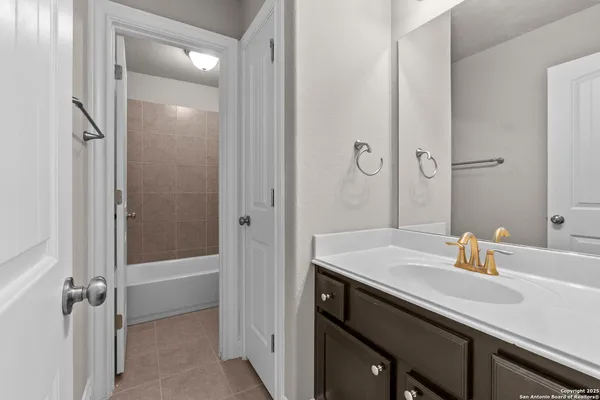 a bathroom with a sink shower and a mirror