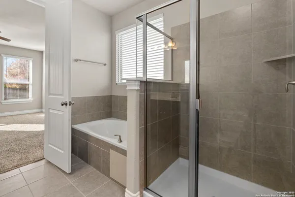 a bathroom with a bathtub and mirror