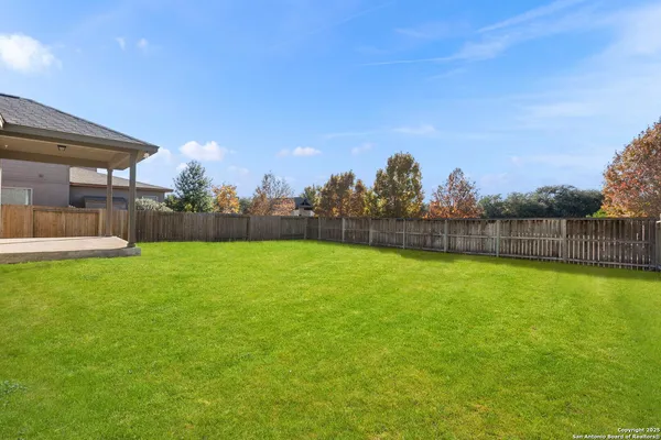 a view of yard with swimming pool and green space
