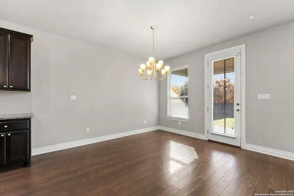 a view of a room with wooden floor and a window