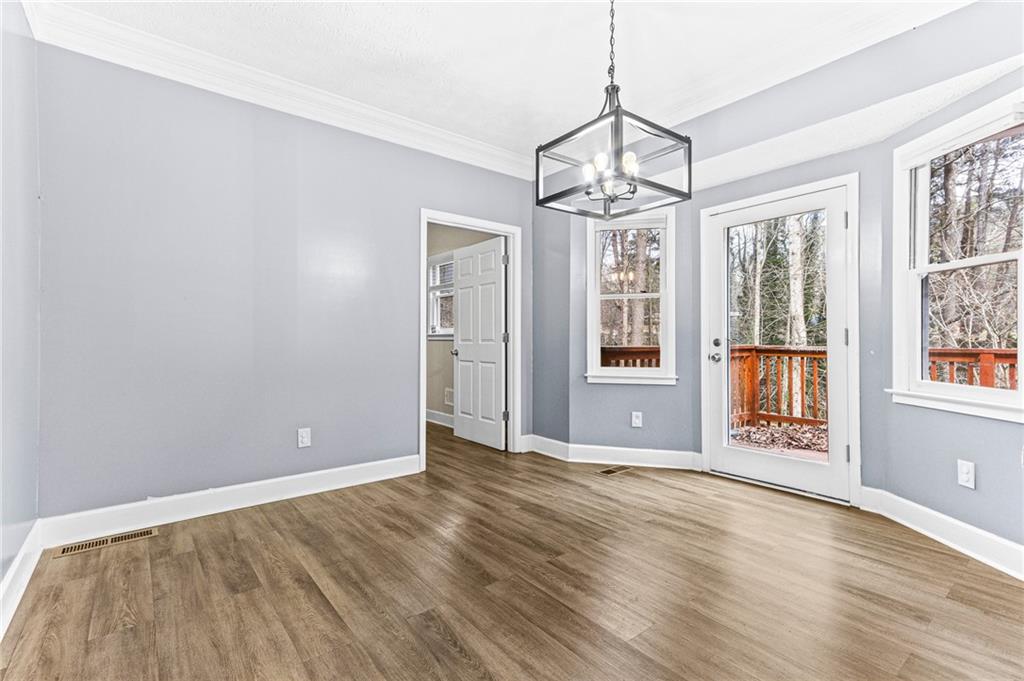 1394 Maple Drive Southwest Lilburn, GA 30047 - Photo 14 of 31 a view of an empty room with wooden floor and a window