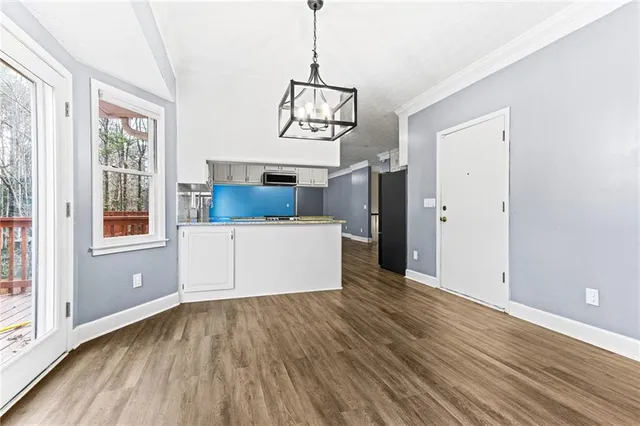 a view of a room with wooden floor and windows
