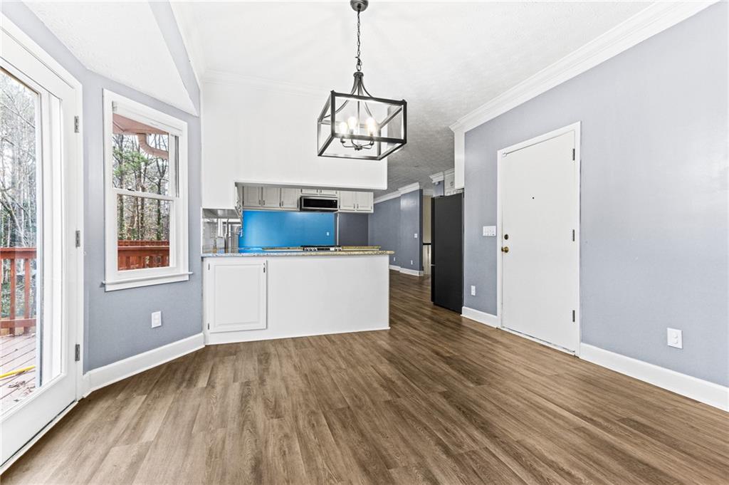 1394 Maple Drive Southwest Lilburn, GA 30047 - Photo 15 of 31 a view of a room with wooden floor and windows