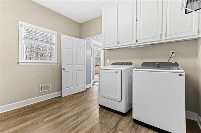 a view of a storage and utility room with washer and dryer