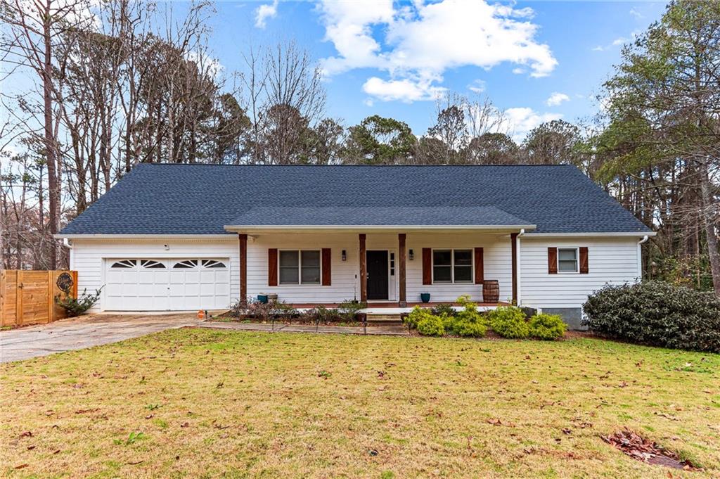 1394 Maple Drive Southwest Lilburn, GA 30047 - Photo 2 of 31 a front view of a house with a yard