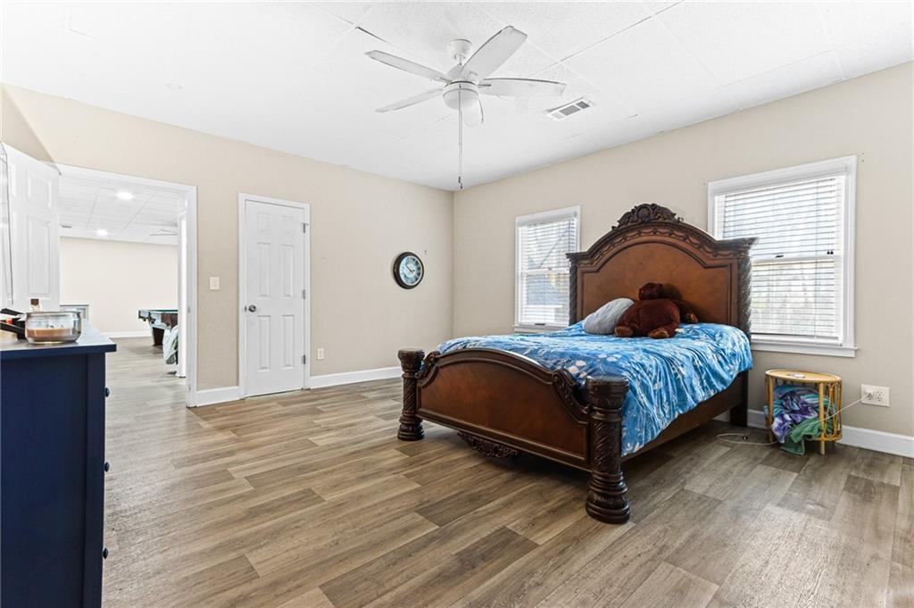 1394 Maple Drive Southwest Lilburn, GA 30047 - Photo 21 of 31 a bedroom with a bed and a chandelier