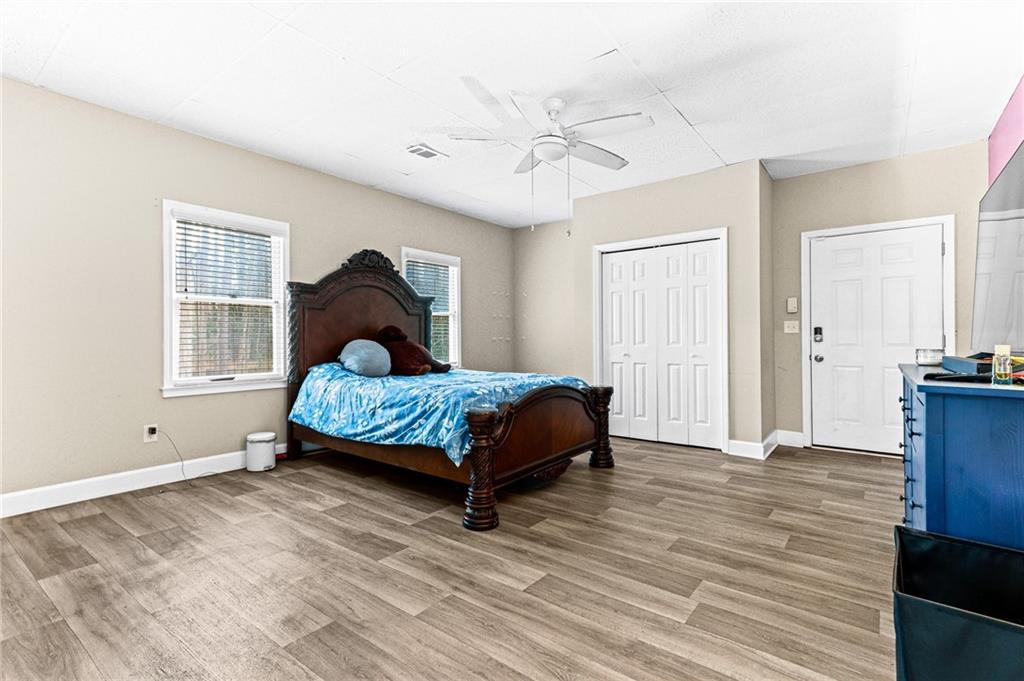 1394 Maple Drive Southwest Lilburn, GA 30047 - Photo 22 of 31 a bedroom with a bed and a chandelier