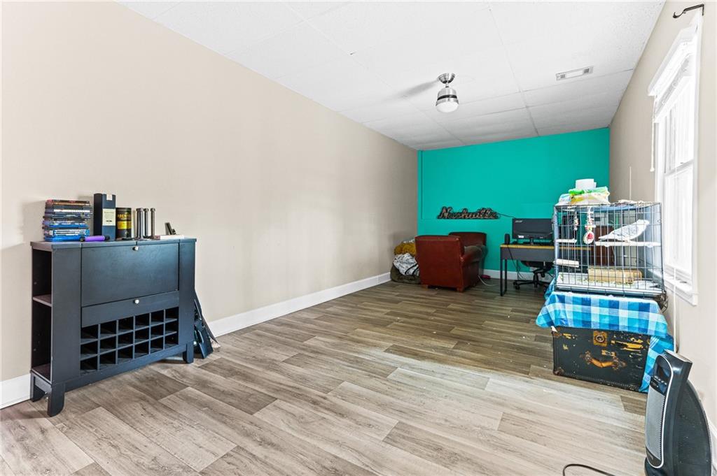 1394 Maple Drive Southwest Lilburn, GA 30047 - Photo 24 of 31 a bedroom with furniture and a wooden floor