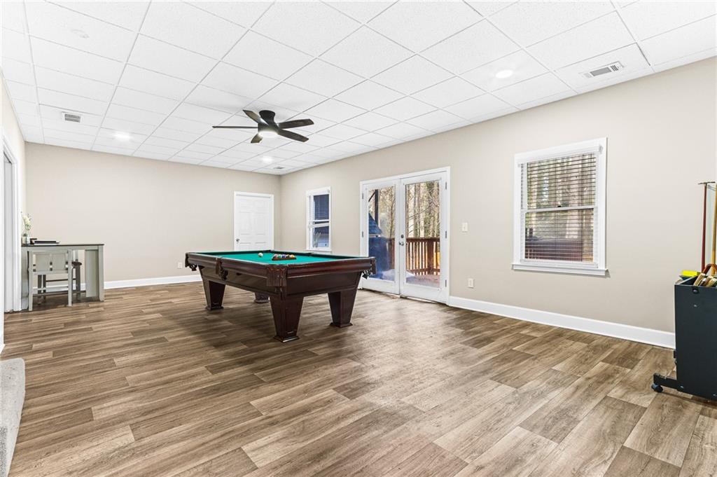 1394 Maple Drive Southwest Lilburn, GA 30047 - Photo 27 of 31 a living room with a table and a fireplace