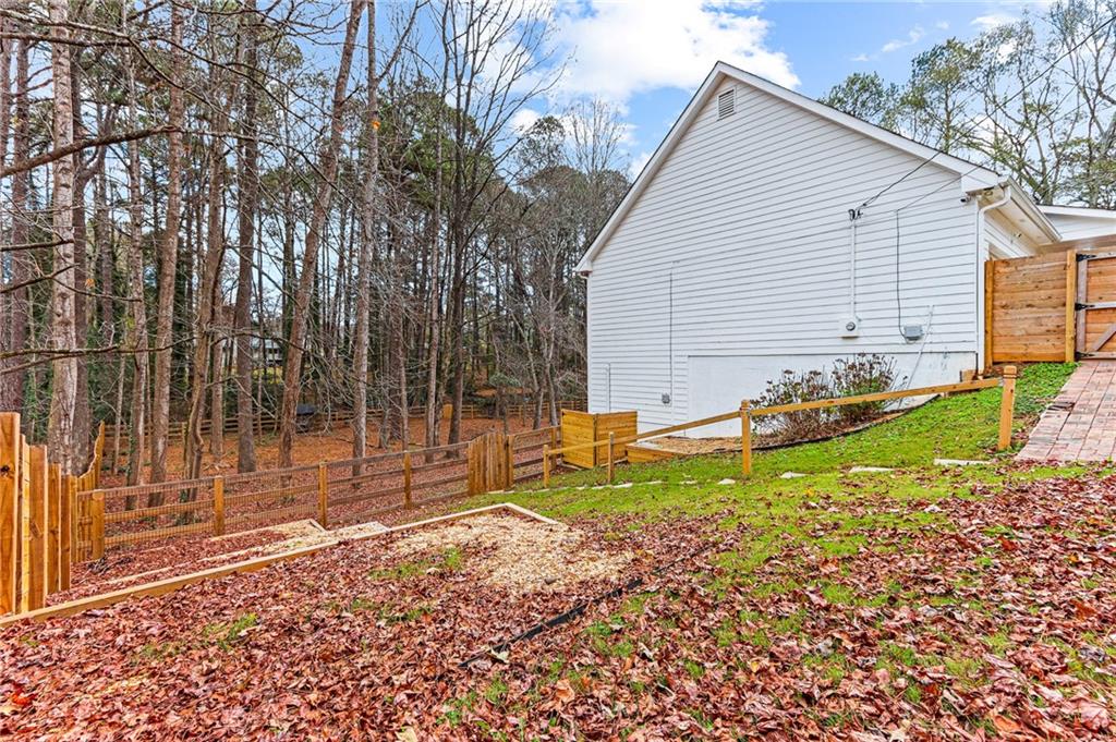 1394 Maple Drive Southwest Lilburn, GA 30047 - Photo 29 of 31 a backyard of a house with lots of green space