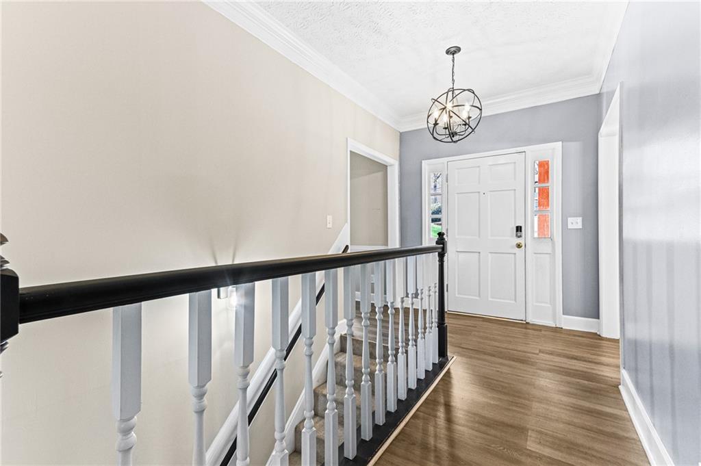 1394 Maple Drive Southwest Lilburn, GA 30047 - Photo 3 of 31 a view of a hallway with wooden floor and stairs
