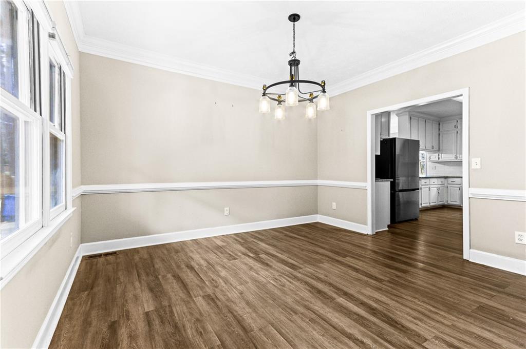 1394 Maple Drive Southwest Lilburn, GA 30047 - Photo 5 of 31 wooden floor in an empty room with a window