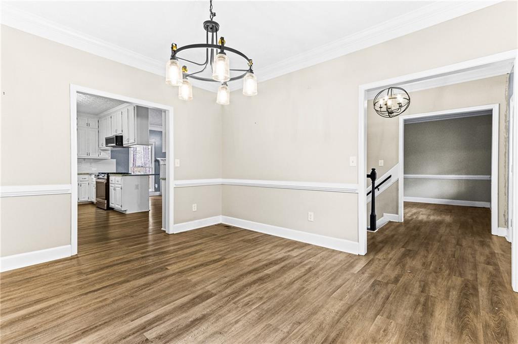 1394 Maple Drive Southwest Lilburn, GA 30047 - Photo 6 of 31 a view of empty room with wooden floor