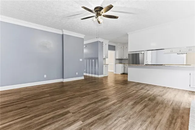 a view of a kitchen with a dishwasher and wooden floor