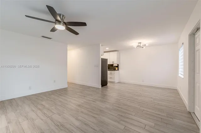 wooden floor in an empty room with a window