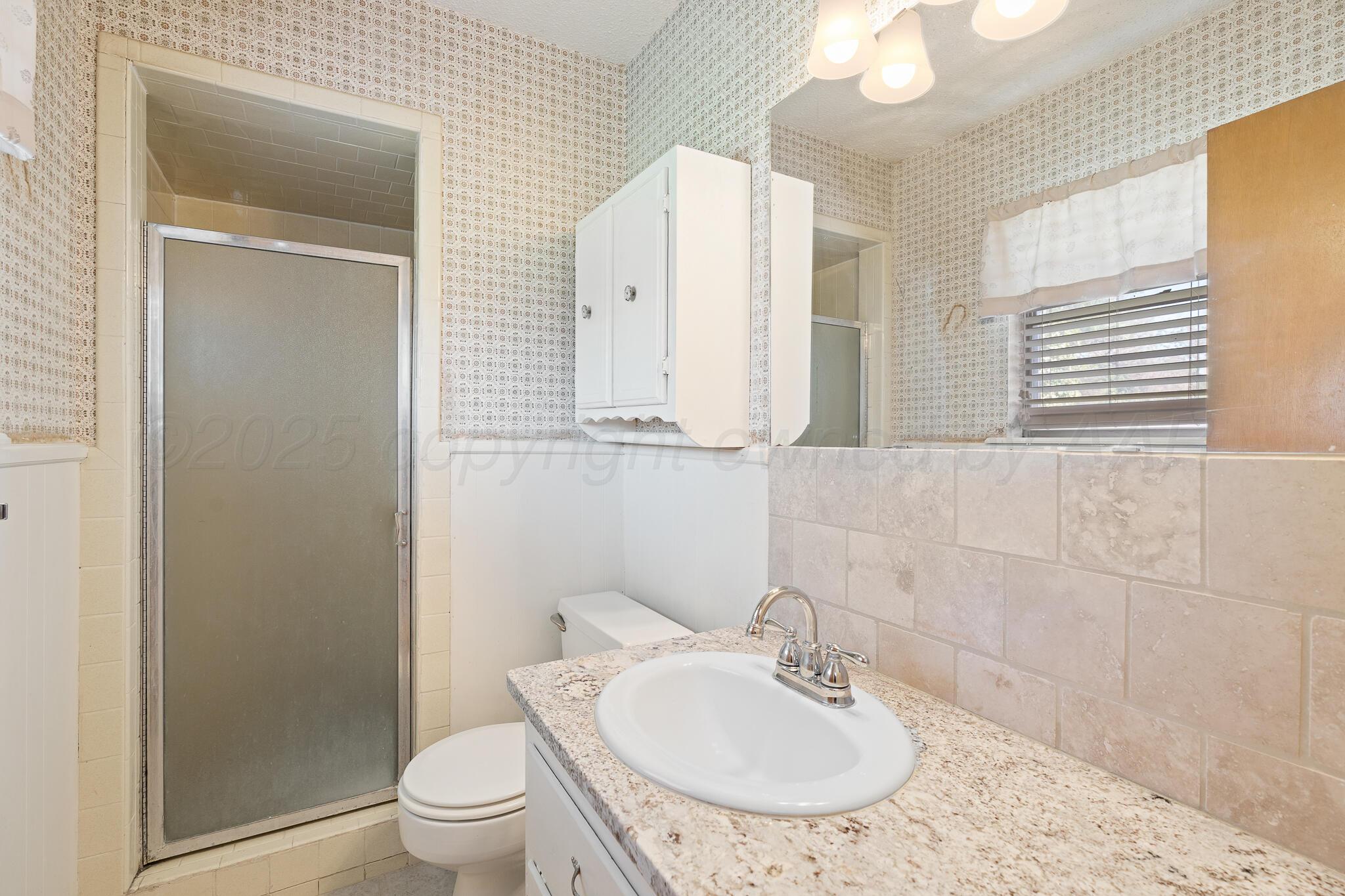 4803 Carole Lane Amarillo, TX 79110 - Photo 12 of 23 a bathroom with a sink toilet and shower