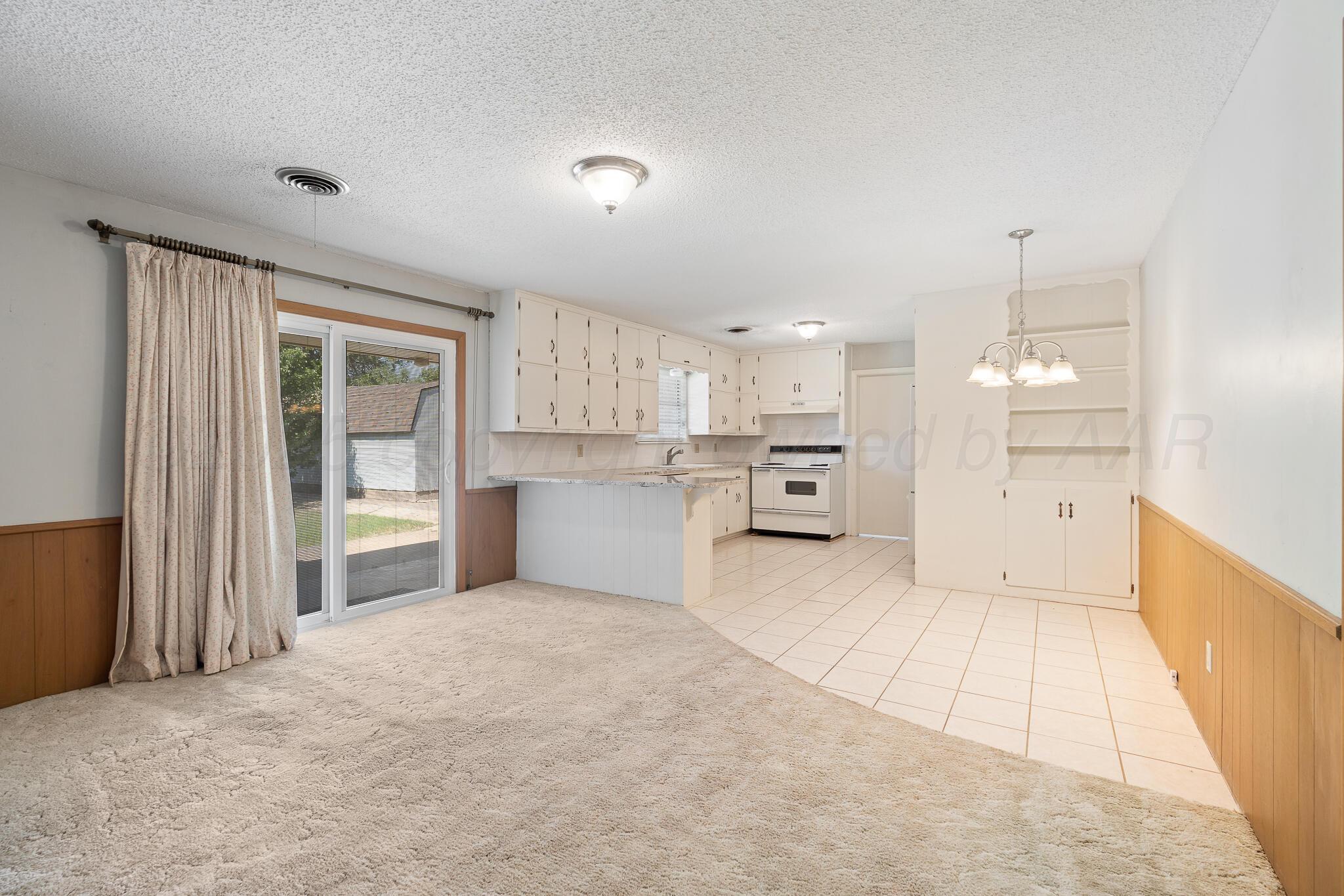 4803 Carole Lane Amarillo, TX 79110 - Photo 4 of 23 a view of a kitchen with white cabinets and refrigerator