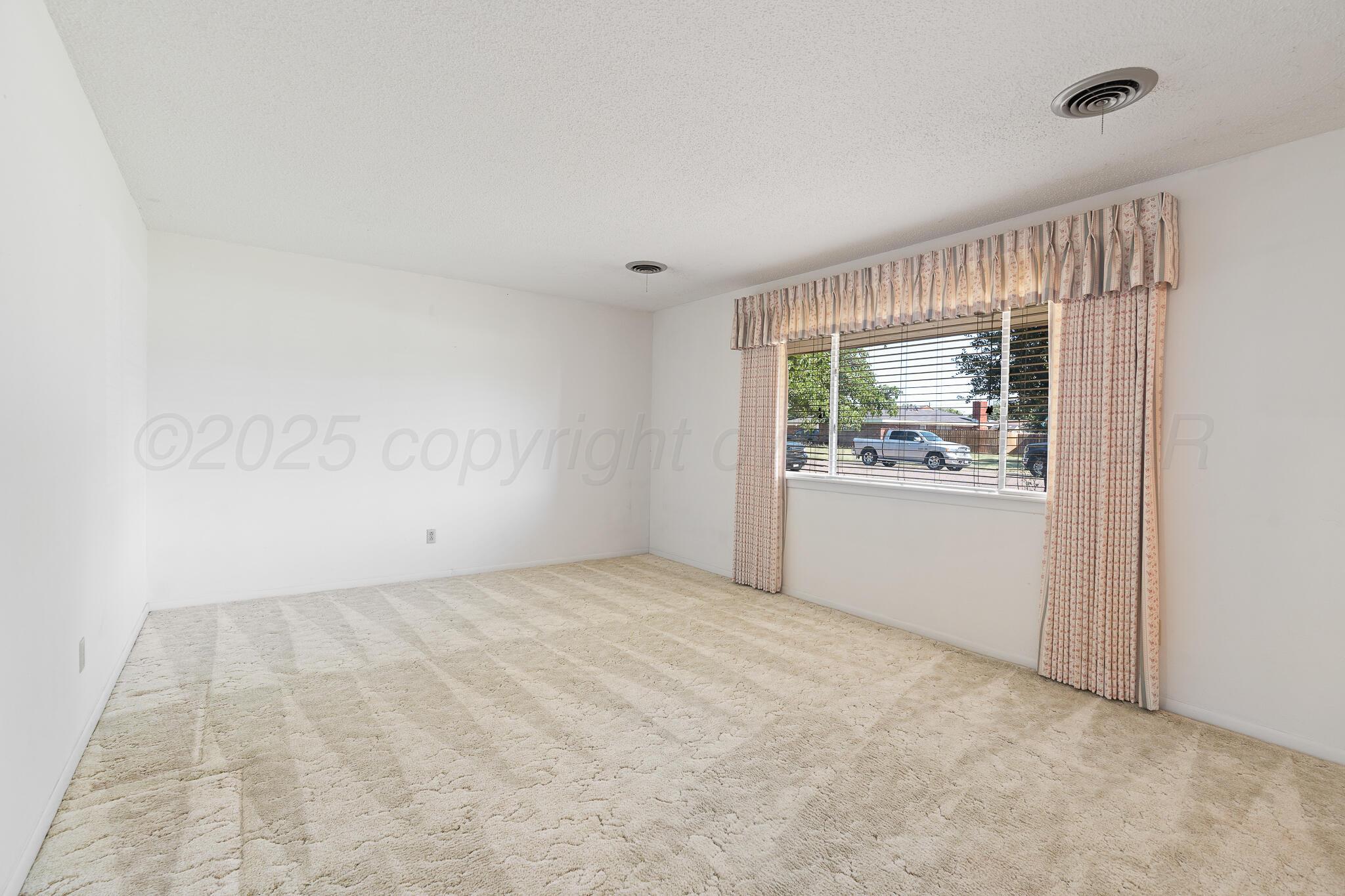4803 Carole Lane Amarillo, TX 79110 - Photo 7 of 23 an empty room with windows