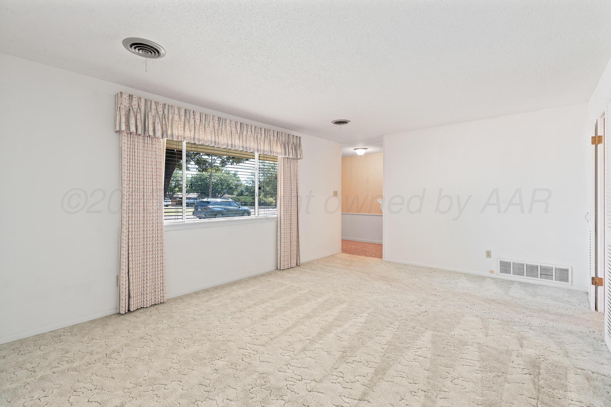 4803 Carole Lane Amarillo, TX 79110 - Photo 8 of 23 a view of an empty room with a window