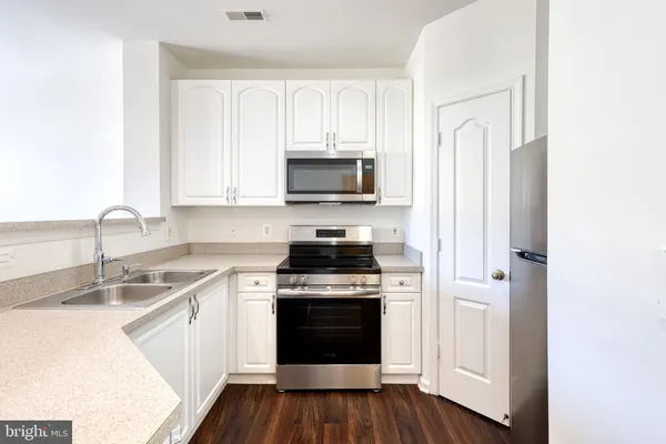 a kitchen with a stove and a sink