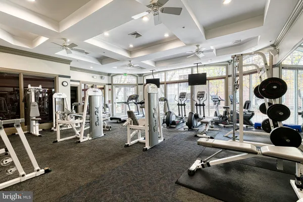 a room with gym equipment and mirrors